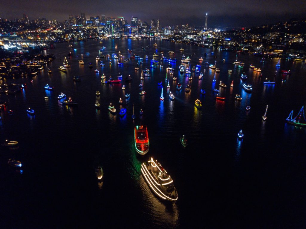 Hundreds of boats lit up with holiday colors on Lake Union in Seattle, Washington during the Christmas Ships Parade