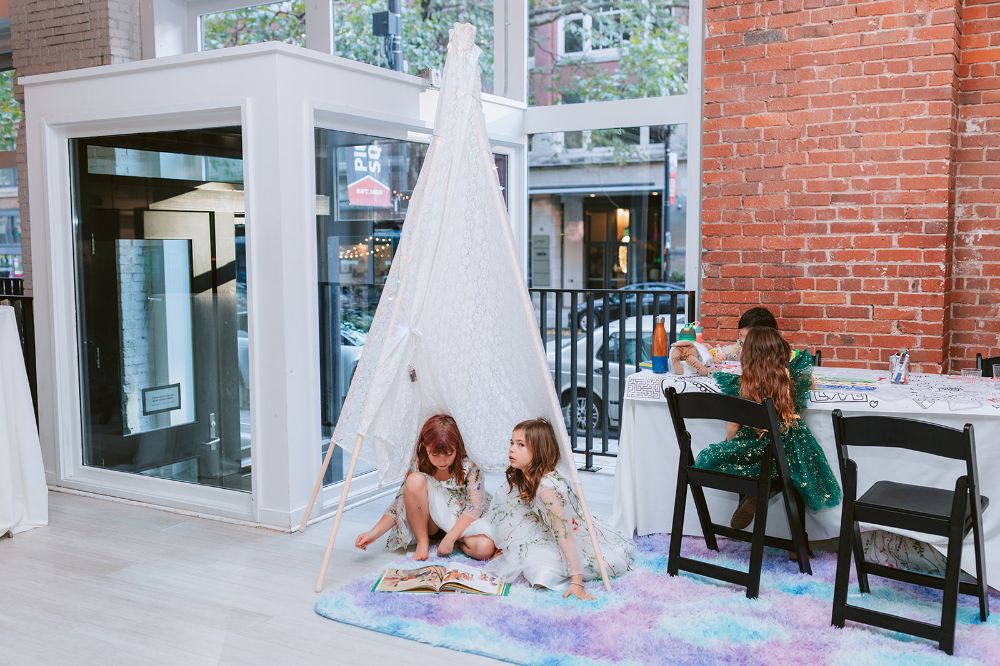 Kids play in a teepee tent at their parent's Seattle wedding