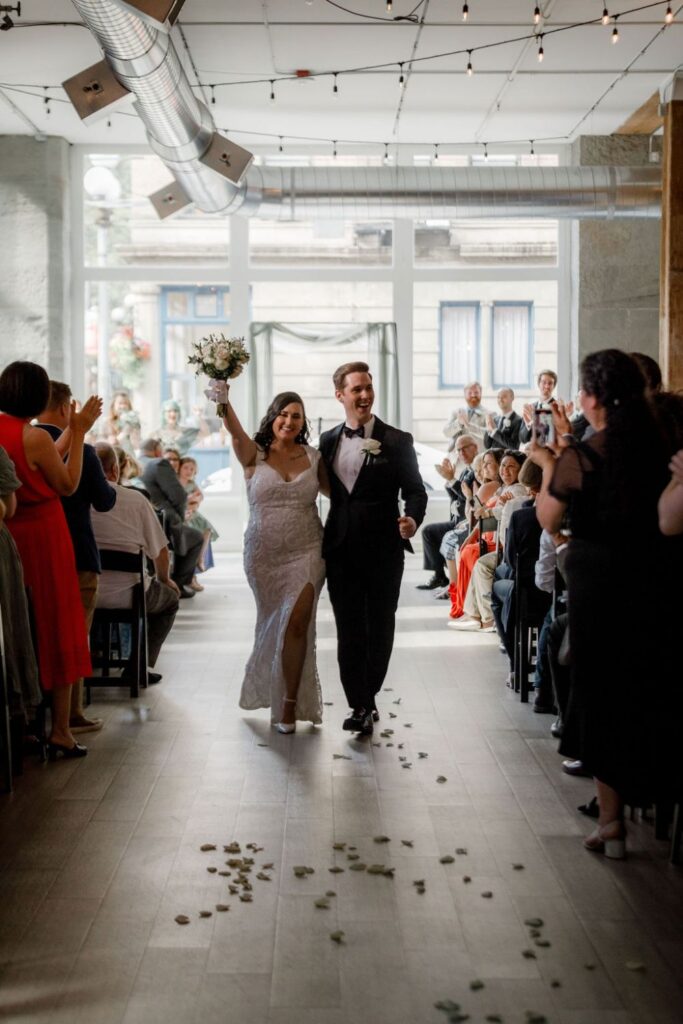 Bride and groom walking down the aisle after saying "I do"