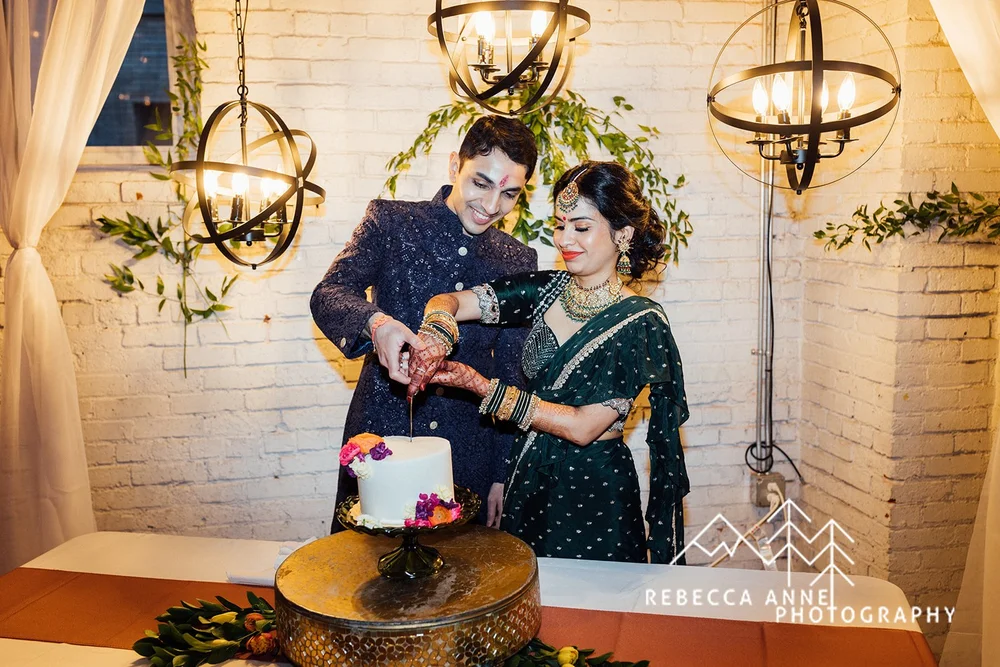 Indian bride and groom cutting cake