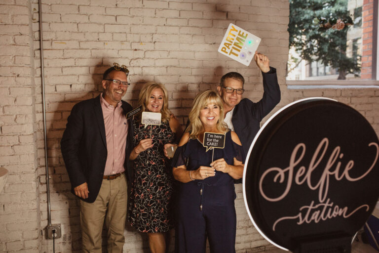 Guests taking a selfie at THE 101's in-house photo booth at Seattle office holiday party.