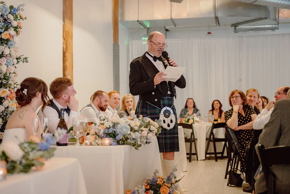 Man giving a speech at a wedding at THE 101 in Seattle