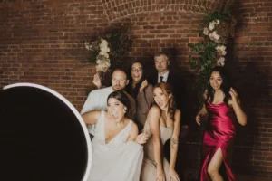 Guests posing in front of the photo booth rented by THE 101