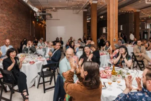 Guests sitting at tables at THE 101 in Seattle during a wedding reception