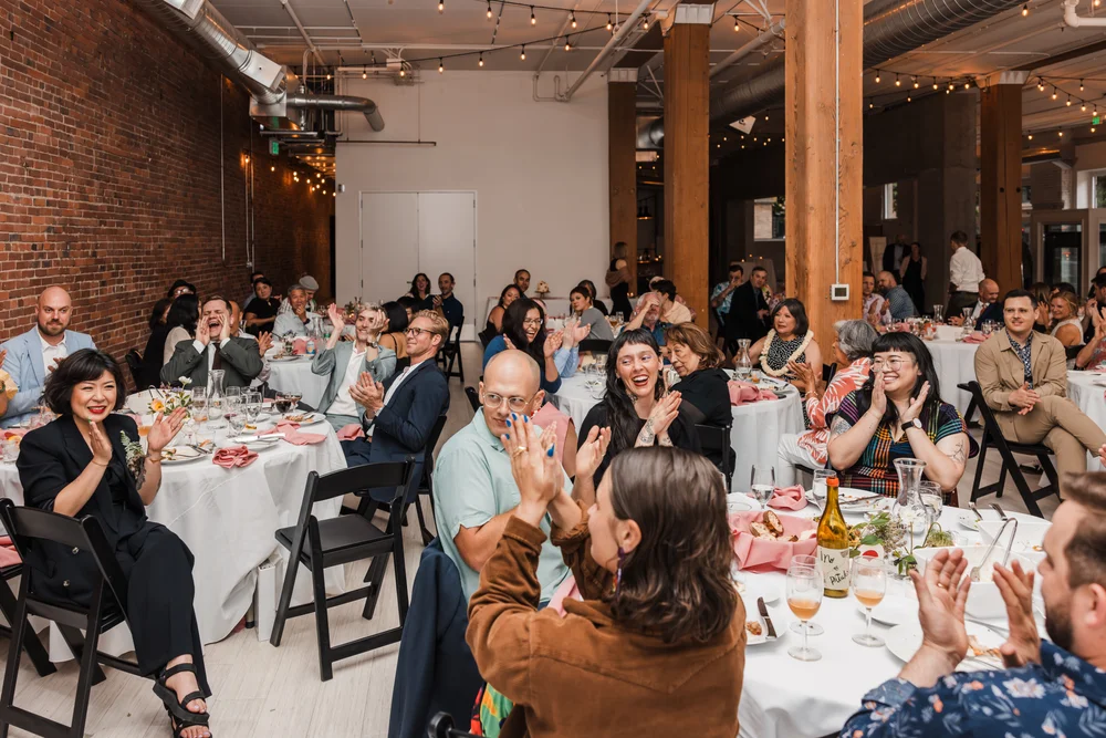 Guests sitting at tables at THE 101 in Seattle during a wedding reception