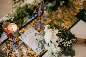 Table setting with colorful runner, white florals and glassware