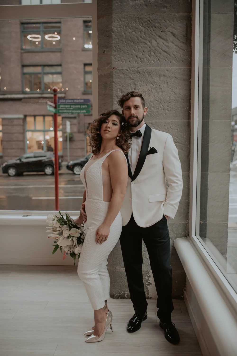 Couple posing for engagement photos at THE 101 in Pioneer Square Seattle