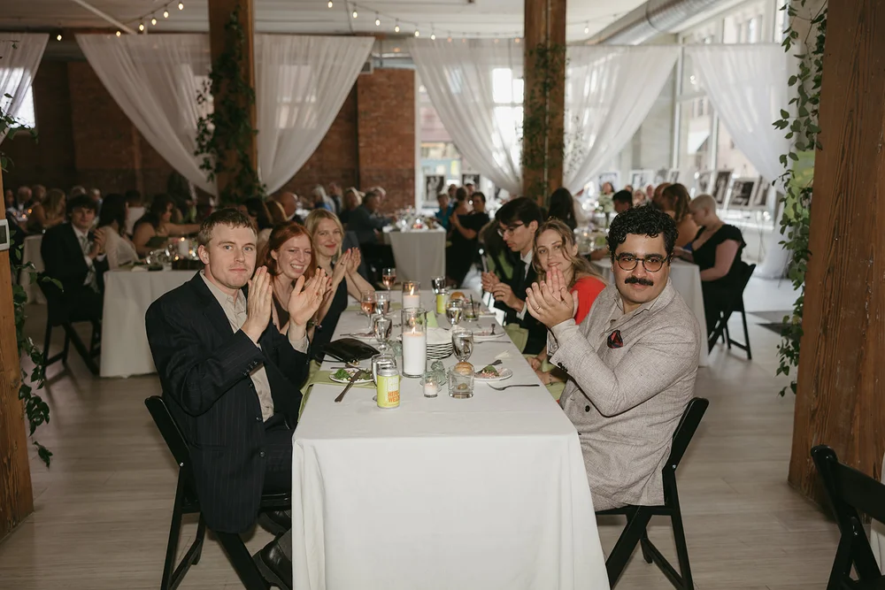 Guests clapping at a wedding at THE 101 in Seattle