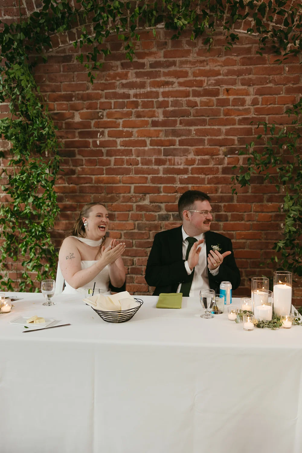 Bride and groom seated at their sweetheart table at their wedding at THE 101 in Seattle