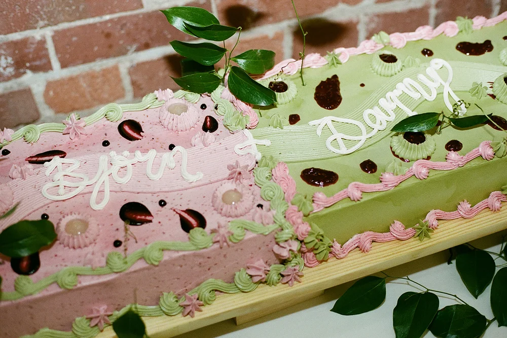 Long rectangular wedding cake with green and pink frosting at THE 101 in Seattle, WA